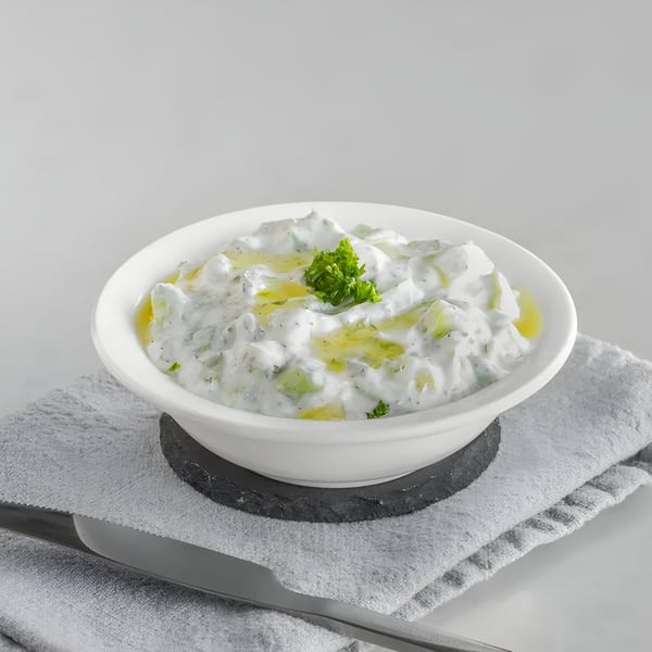 Tarme Mediterranean Grill's tzatziki, a white dip with cucumber, dill, and olive oil, garnished with parsley.